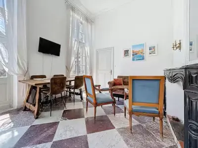 a living room with a table and chairs at Charmant T2 Narbonne centre in Narbonne