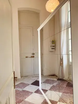a hallway with a door and a tiled floor at Charmant T2 Narbonne centre in Narbonne