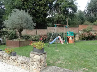 a yard with a playground and a swing at Beautiful 17th century character residence in Fontiers-Cabardès