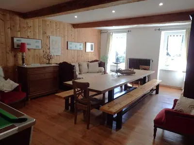 a living room with a table and a couch at Beautiful 17th century character residence in Fontiers-Cabardès