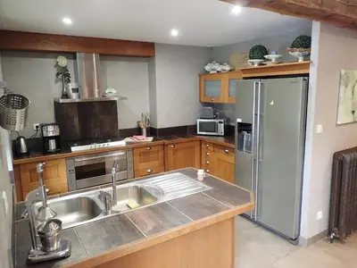 a kitchen with a sink and a refrigerator at Beautiful 17th century character residence in Fontiers-Cabardès
