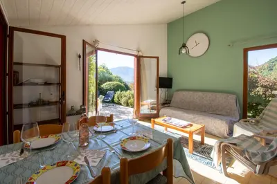 a living room with a table and a couch at La Petite Étoile - Maison 2 Chambres à Quillan in Quillan