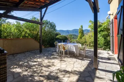 a table and chairs on a patio with a view at La Petite Étoile - Maison 2 Chambres à Quillan in Quillan