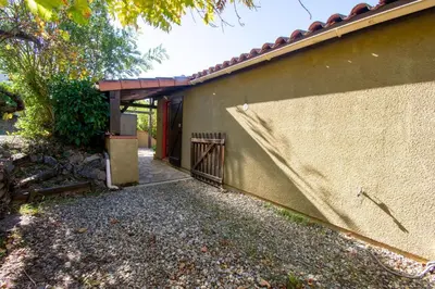 a house with a fence next to a building at La Petite Étoile - Maison 2 Chambres à Quillan in Quillan