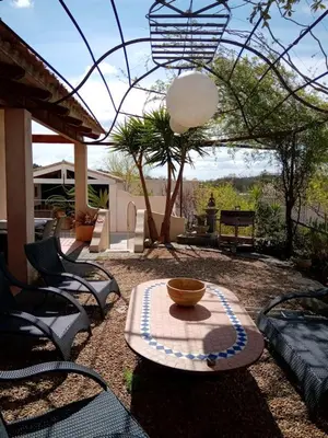 a patio with chairs and a bowl on a table at Villa couleurs du sud in Bize-Minervois