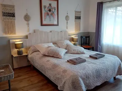 a bedroom with a large bed with two towels on it at Villa couleurs du sud in Bize-Minervois