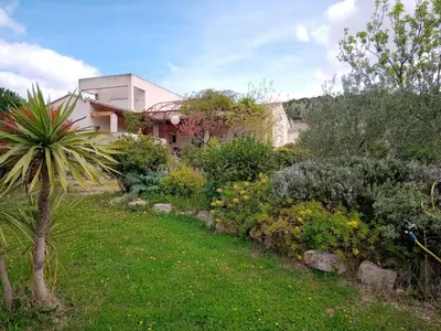 a garden in front of a house at Villa couleurs du sud in Bize-Minervois