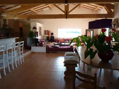 a living room with a table and a couch at Villa couleurs du sud in Bize-Minervois