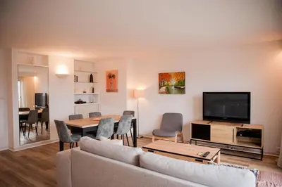 a living room with a couch and a tv at L'Oeil sur la Cité in Carcassonne