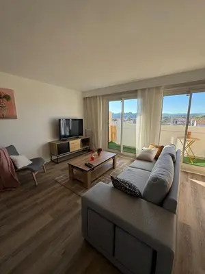 a living room with a table and a couch at L'Oeil sur la Cité in Carcassonne
