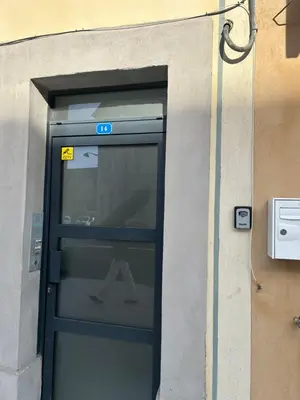 an entrance to a building with a glass door at Les berges de la cité in Carcassonne