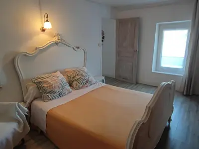 a bedroom with a large bed with two pillows on it at Chez Christine et Fred in Villedaigne