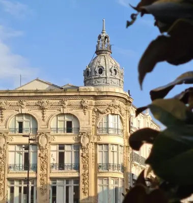 a building with a tower on top of it at Grand appartement centre historique in Narbonne