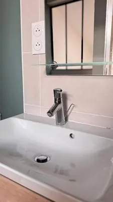 a white sink in a bathroom with a mirror at T2 cosy tout équipé, parking et wifi gratuit, Castres in Castres