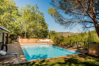 a swimming pool in the backyard of a house at La Colline aux Oiseaux - Quatre chambres in Fa