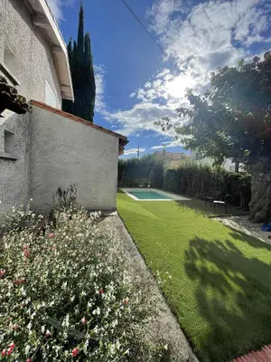 a swimming pool with blue water in a yard at Comme à la maison B and B - 2 chambres et 1 salon in Carcassonne