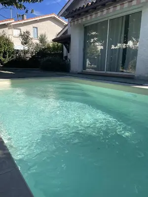 a backyard with a lawn and a swimming pool at Comme à la maison B and B - 2 chambres et 1 salon in Carcassonne