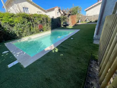 a river with trees and a boat in the water at Comme à la maison B and B - 2 chambres et 1 salon in Carcassonne