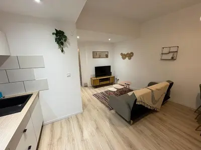 a living room with a couch and a television at Comme à la maison in Carcassonne