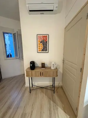 a small table in a room with a door at Comme à la maison in Carcassonne