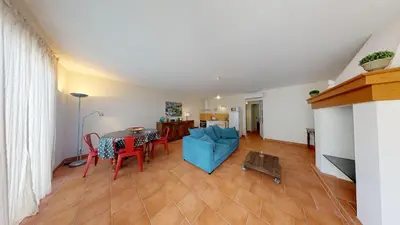 a living room with a table and a blue couch at Domaine Paul Huc in Fabrezan