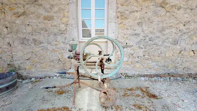 a metal object in front of a brick wall at Domaine Paul Huc in Fabrezan