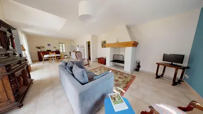 a living room with a couch and a tv at Domaine Paul Huc in Fabrezan