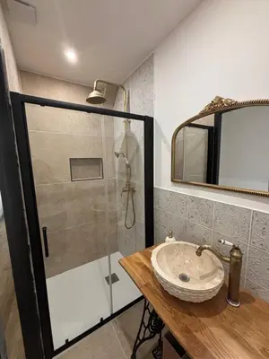 a bathroom with a sink and a shower at La Table du Chevalier - Cité in Carcassonne