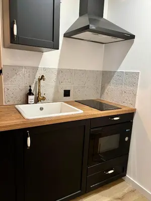 a kitchen with a sink and a stove at La Table du Chevalier - Cité in Carcassonne