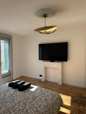 a bedroom with a large bed with a flat screen tv at La Table du Chevalier - Cité in Carcassonne