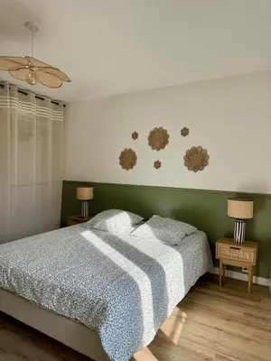 a bedroom with a bed and two night stands and two lamps at Le Petit Faubourg - Cocooning and bright - Cité in Carcassonne