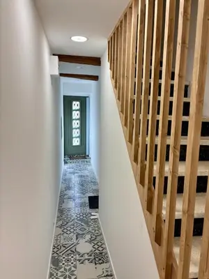 a hallway with stairs and a tile floor at Le Petit Faubourg - Cocooning and bright - Cité in Carcassonne