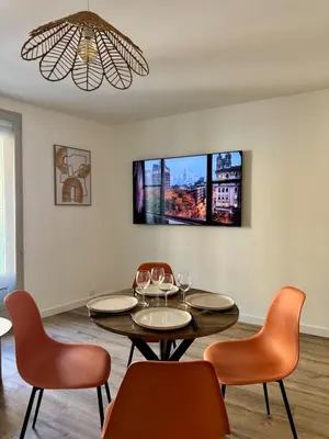 a dining room with a table and chairs at Le Petit Faubourg - Cocooning and bright - Cité in Carcassonne