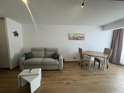 a living room with a couch and a table at Vacances à Gruissan in Gruissan