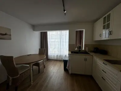 a kitchen with a table and chairs and a dining room at Vacances à Gruissan in Gruissan