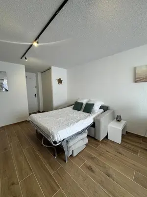 a bedroom with a bed and a couch in it at Vacances à Gruissan in Gruissan