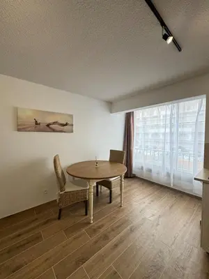 a dining room with a table and chairs and a large window at Vacances à Gruissan in Gruissan