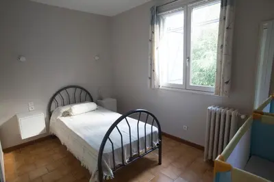 a bedroom with a bed and a window at La Maison de Jack in Raissac-dʼAude
