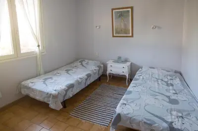a bedroom with a bed and a table and a window at La Maison de Jack in Raissac-dʼAude