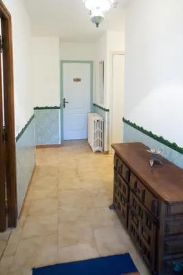 a hallway with a wooden floor and a door at La Maison de Jack in Raissac-dʼAude