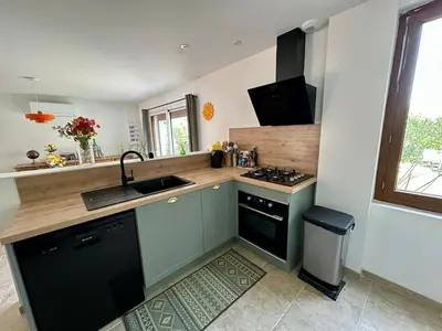 a kitchen with a sink and a stove at Maison tout confort proche centre avec jardin in Carcassonne