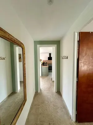 a room with a mirror and a hallway with a door at Maison tout confort proche centre avec jardin in Carcassonne