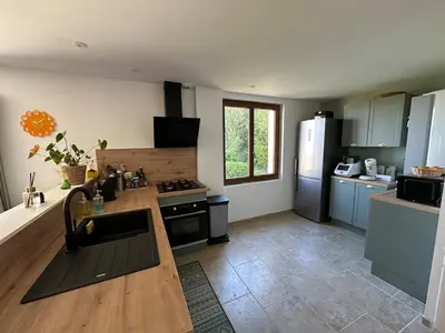 a kitchen with blue cabinets and a counter top at Maison tout confort proche centre avec jardin in Carcassonne