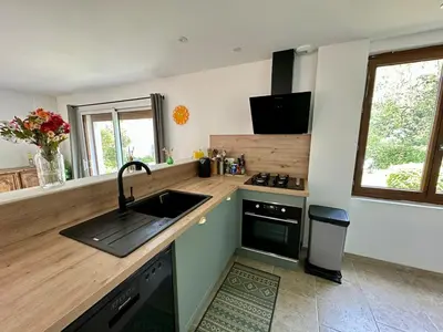 a kitchen with a sink and a stove at Maison tout confort proche centre avec jardin in Carcassonne
