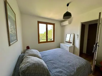 a bedroom with a bed and a window at Maison tout confort proche centre avec jardin in Carcassonne