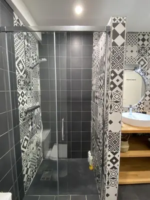 a bathroom with a shower and a sink at Le jardin du Griffoul in Nébias