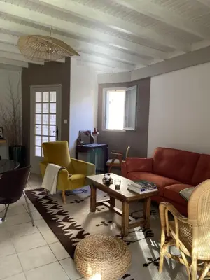 a living room with a couch and a table at Le jardin du Griffoul in Nébias