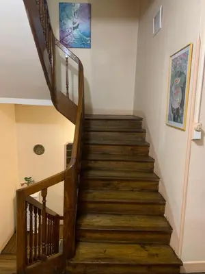 a staircase in a home with wooden steps at Chambres d hôtes H in Lavelanet