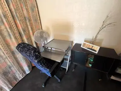 a room with a desk and a table and a chair at maison chalet in Bessède-de-Sault