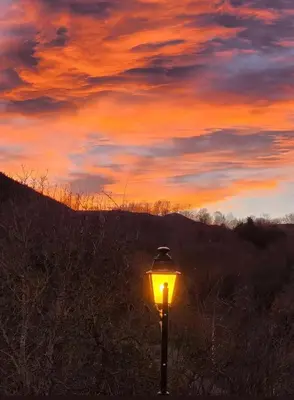 a street light with a sunset in the background at maison chalet in Bessède-de-Sault